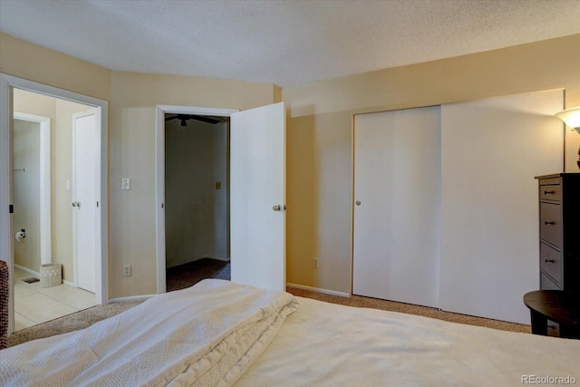 562 W Crestline Cir Unit 7D, Littleton, CO 80120 - bedroom with carpet, a closet, and a textured ceiling