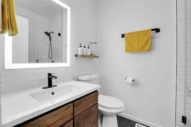 bathroom featuring walk in shower, vanity, and toilet