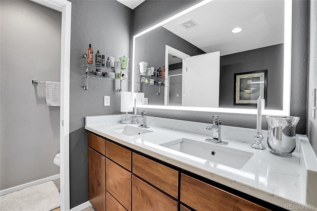 bathroom with vanity and toilet