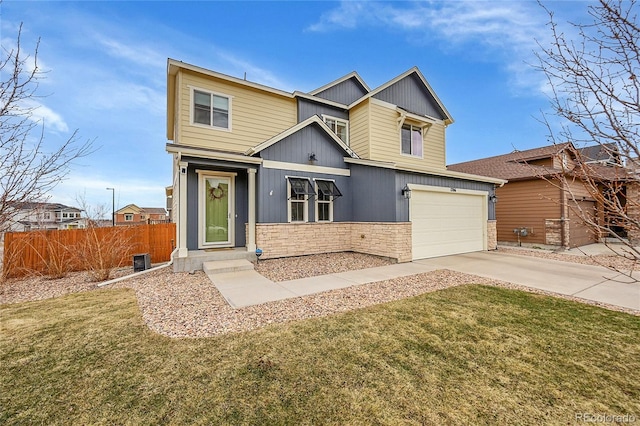 craftsman-style home featuring concrete driveway, fence, a garage, stone siding, and a front lawn