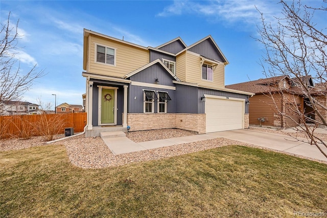 craftsman-style house with concrete driveway, an attached garage, fence, stone siding, and a front lawn