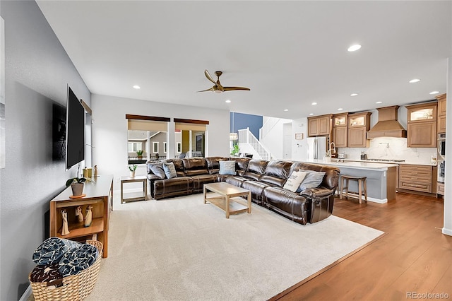 living area with a ceiling fan, stairway, dark wood-style flooring, and recessed lighting