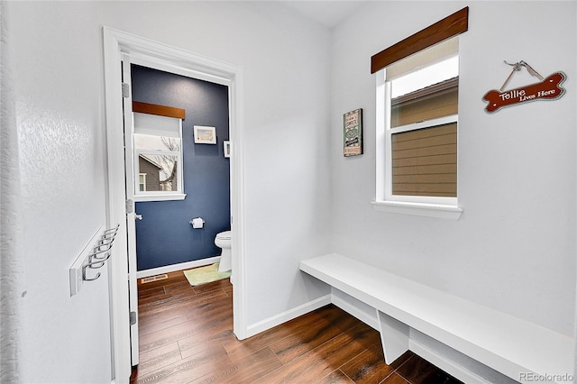 mudroom featuring dark wood-style floors, baseboards, and visible vents