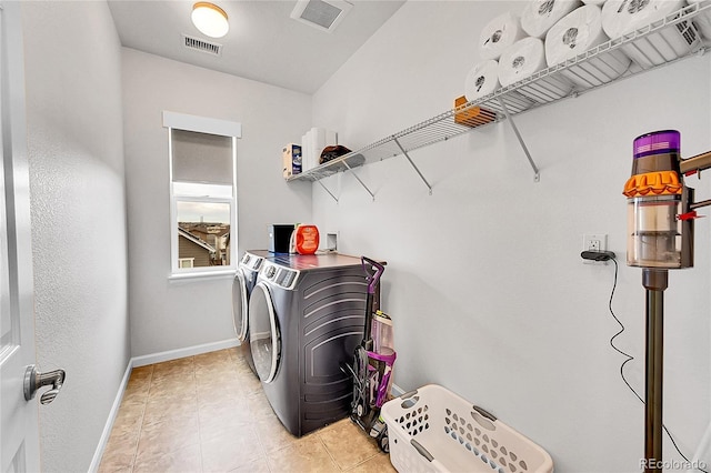 laundry area featuring washer and dryer, laundry area, visible vents, and baseboards