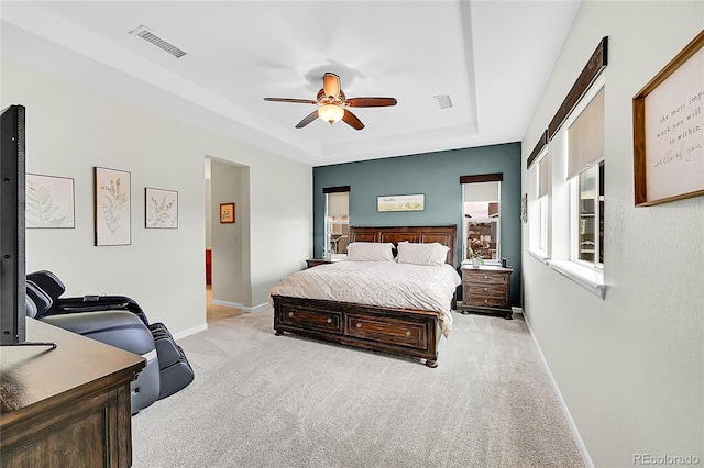 bedroom with baseboards, visible vents, a ceiling fan, a raised ceiling, and carpet flooring