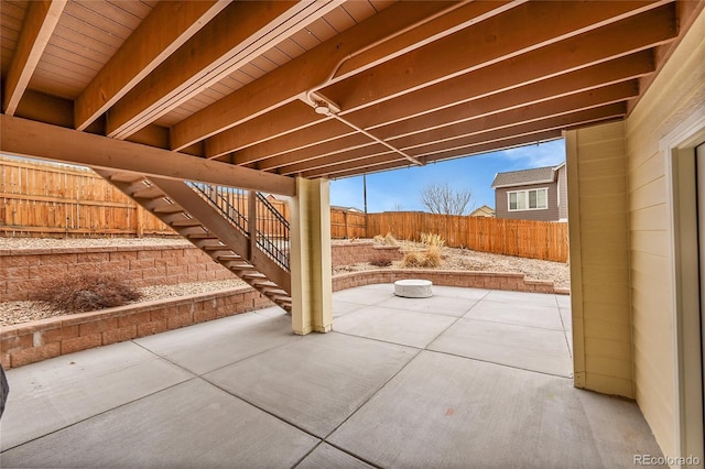 view of patio / terrace featuring a fenced backyard and stairway