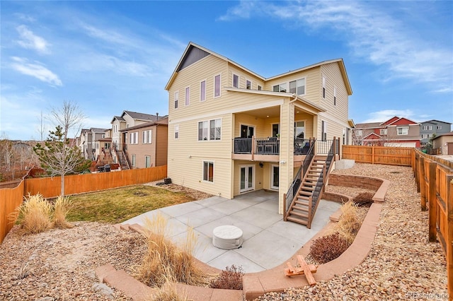 back of house with a patio, stairway, a fenced backyard, and a residential view