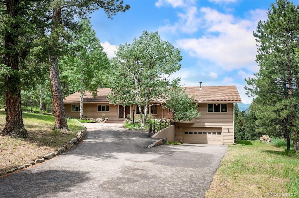 260 Whiskey Jay Hill Rd, Evergreen, CO 80439 - view of front facade featuring driveway and a garage