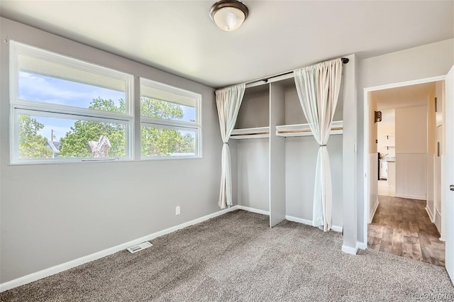 unfurnished bedroom with carpet floors and a closet