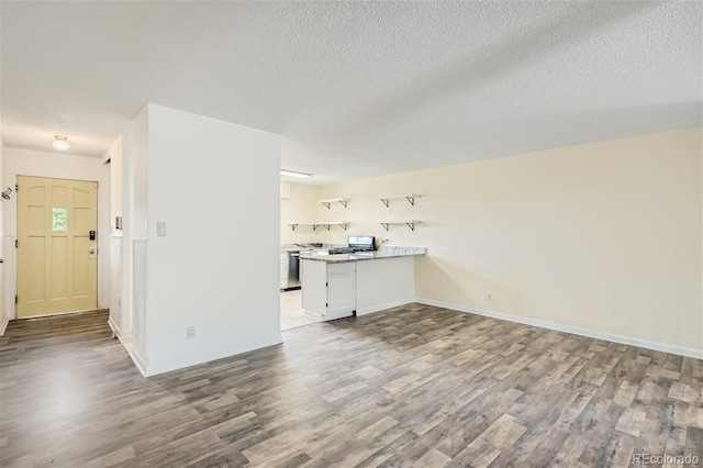 unfurnished living room with a textured ceiling and hardwood / wood-style floors