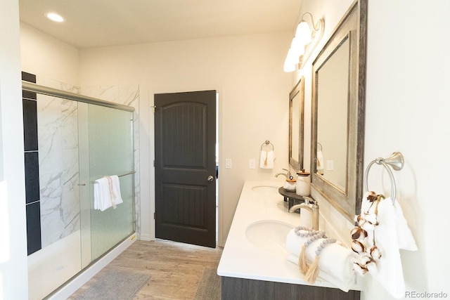 bathroom featuring hardwood / wood-style floors, vanity, and an enclosed shower