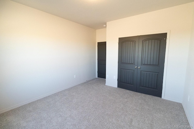 unfurnished bedroom featuring carpet floors and a closet