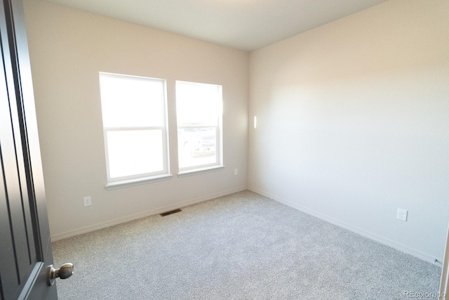 unfurnished room with light colored carpet