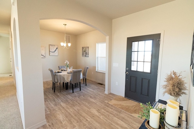 entrance foyer featuring light hardwood / wood-style floors and a chandelier