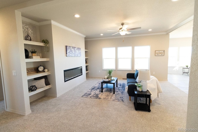 carpeted living room featuring a textured ceiling, ceiling fan, built in features, and ornamental molding