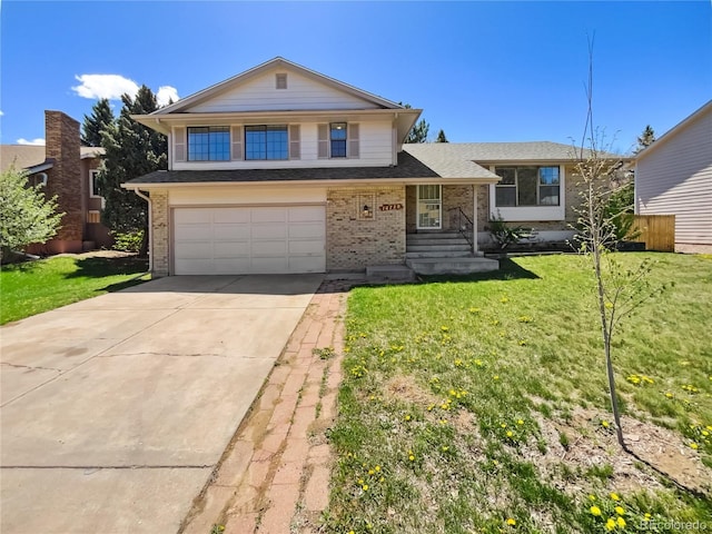 split level home with a front lawn, brick siding, a shingled roof, an attached garage, and driveway