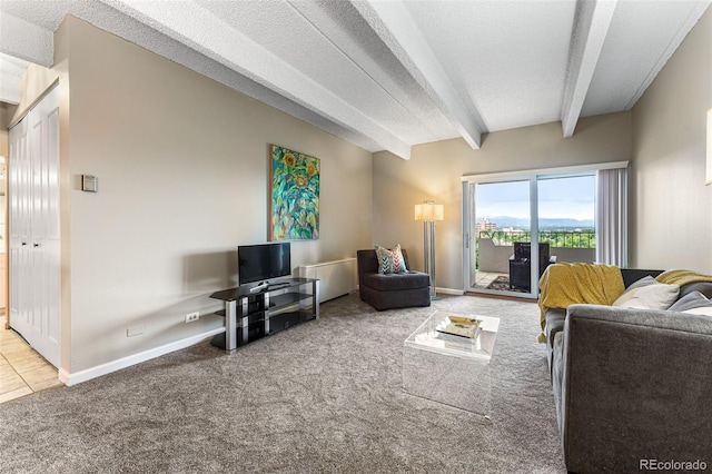 carpeted living room with a textured ceiling, baseboards, and beam ceiling