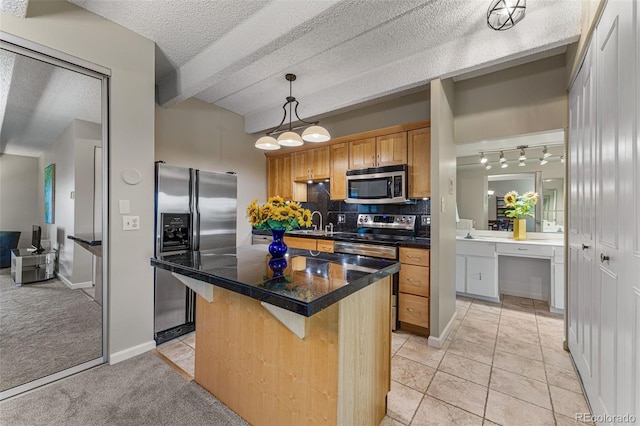 kitchen featuring light colored carpet, a kitchen breakfast bar, appliances with stainless steel finishes, a center island, and dark countertops