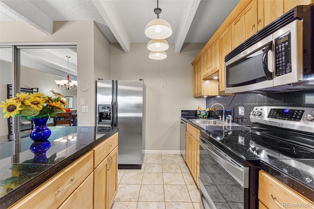 kitchen with a sink, appliances with stainless steel finishes, light brown cabinets, and tile counters