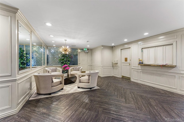 interior space featuring a chandelier, recessed lighting, and a decorative wall