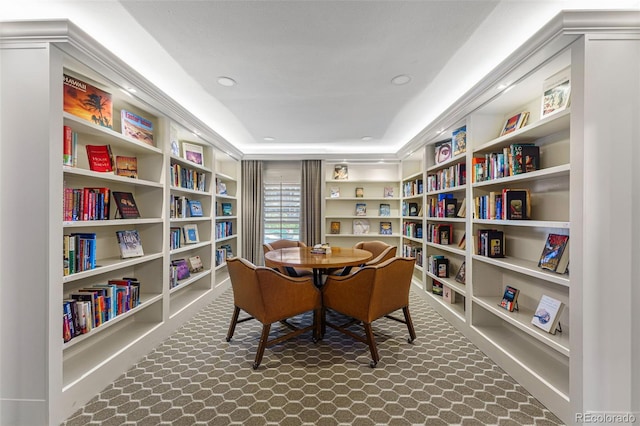 interior space featuring built in features, recessed lighting, and a raised ceiling