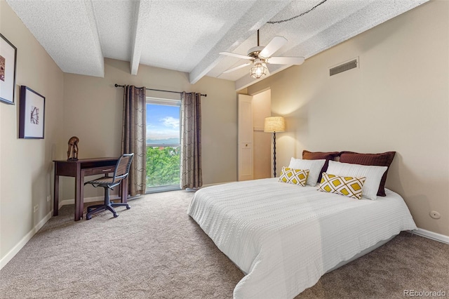 carpeted bedroom featuring baseboards, visible vents, beamed ceiling, access to exterior, and a textured ceiling