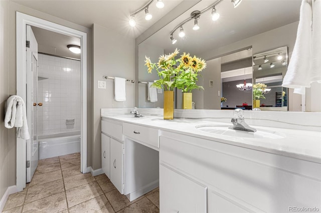 full bath featuring double vanity, tub / shower combination, a sink, and baseboards