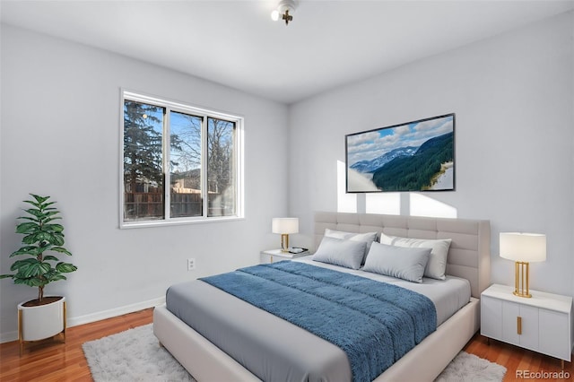 bedroom with hardwood / wood-style flooring