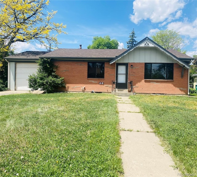 153 S Pierce St, Lakewood, CO 80226 - ranch-style house featuring brick siding, a front lawn, an attached garage, and board and batten siding