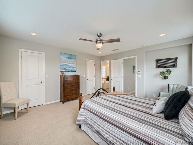 carpeted bedroom with ceiling fan and ensuite bathroom