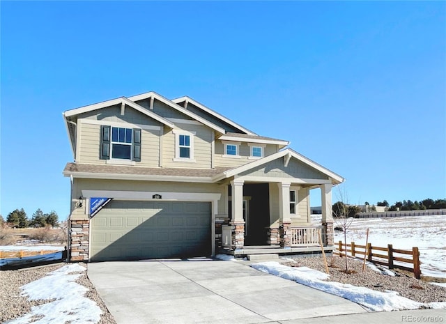 craftsman inspired home with a garage and a porch