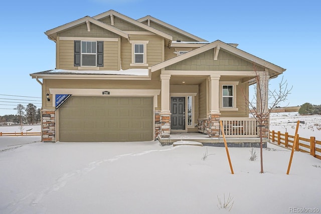 craftsman inspired home with a garage and covered porch