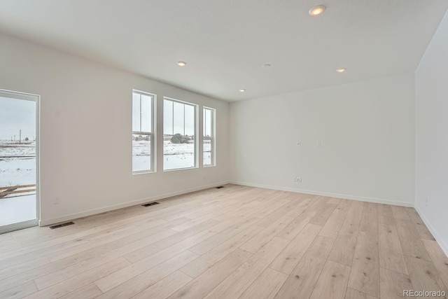 spare room with light hardwood / wood-style flooring