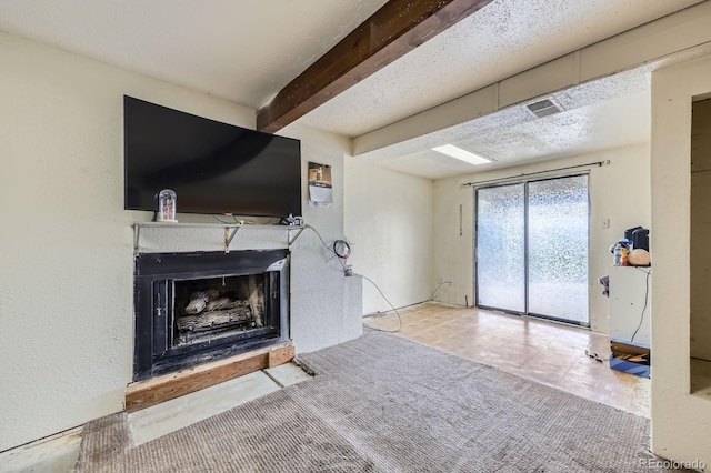 unfurnished living room with a fireplace and beamed ceiling