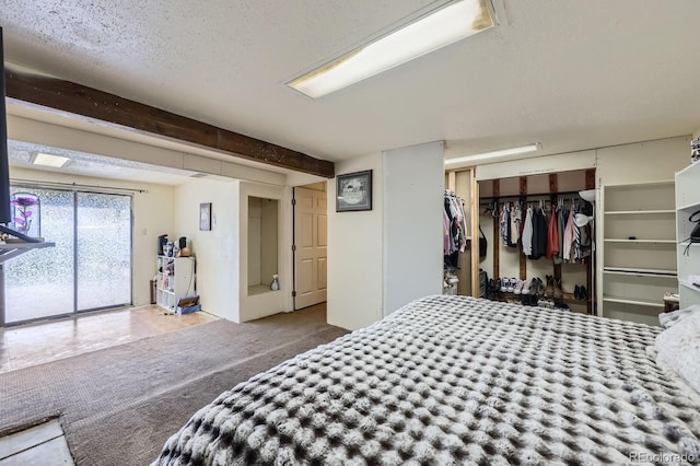 bedroom featuring a closet, carpet flooring, and a textured ceiling