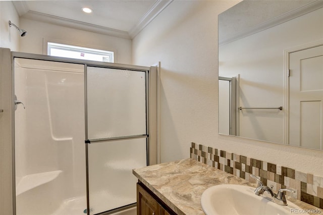 bathroom with walk in shower, decorative backsplash, vanity, and ornamental molding