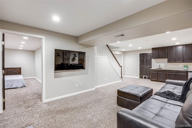 living area with light colored carpet, stairway, baseboards, and recessed lighting