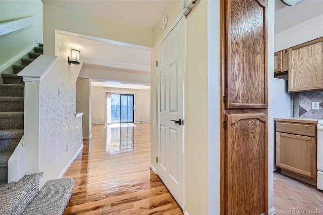 hall featuring light wood-style floors and stairs