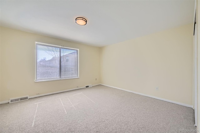 unfurnished room featuring carpet floors, baseboards, and visible vents