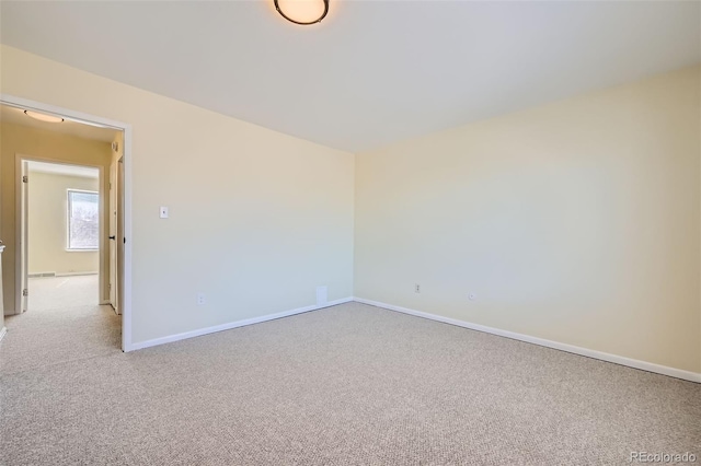 empty room with light carpet and baseboards