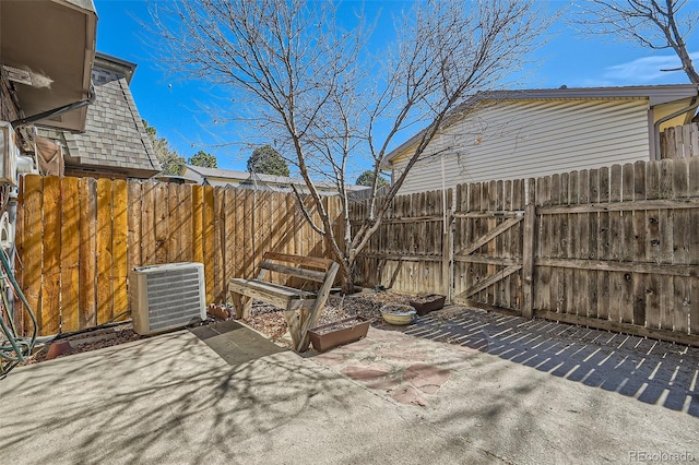 view of patio featuring central air condition unit and fence