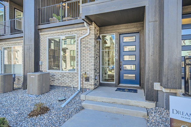 doorway to property with a balcony and central AC