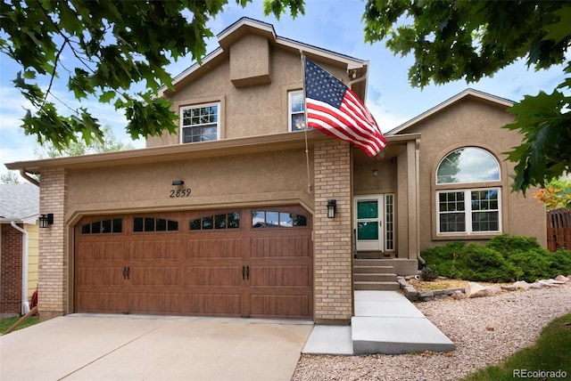 2859 Front Royal Dr, Colorado Springs, CO 80919 - view of front of property featuring stucco siding, driveway, and brick siding