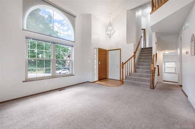 2859 Front Royal Dr, Colorado Springs, CO 80919 - entrance foyer featuring carpet, a towering ceiling, healthy amount of natural light, and stairs