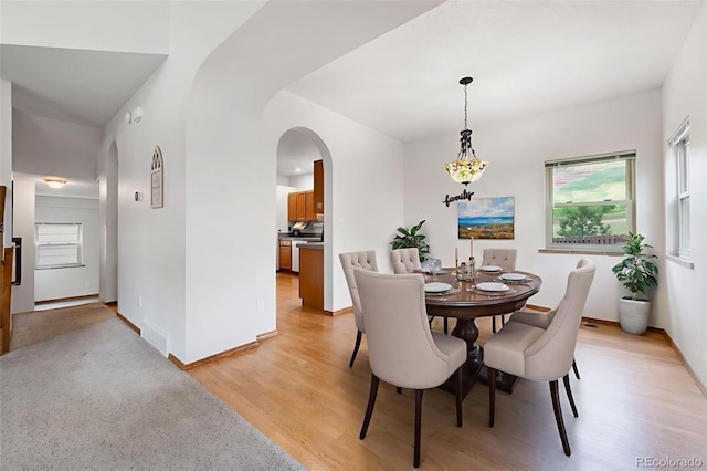 2859 Front Royal Dr, Colorado Springs, CO 80919 - dining space featuring arched walkways and light wood-style floors
