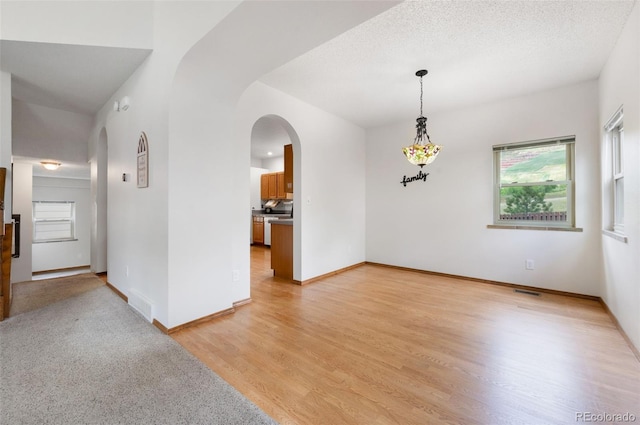 2859 Front Royal Dr, Colorado Springs, CO 80919 - unfurnished room with arched walkways and light wood-style floors