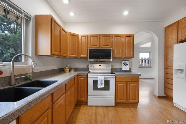 2859 Front Royal Dr, Colorado Springs, CO 80919 - kitchen with white appliances, healthy amount of natural light, light wood-type flooring, brown cabinetry, and recessed lighting