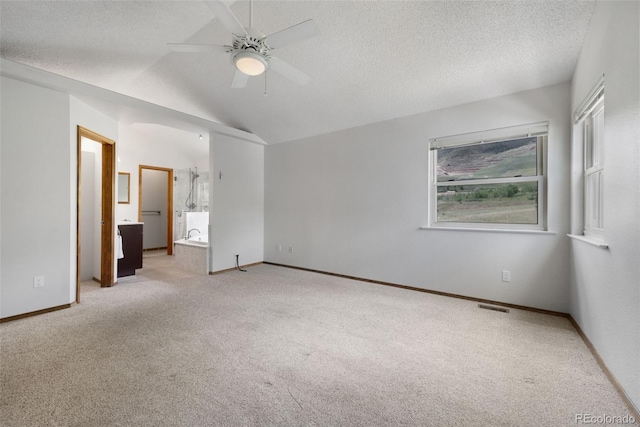 2859 Front Royal Dr, Colorado Springs, CO 80919 - unfurnished bedroom featuring carpet floors, vaulted ceiling, ensuite bathroom, ceiling fan, and a textured ceiling