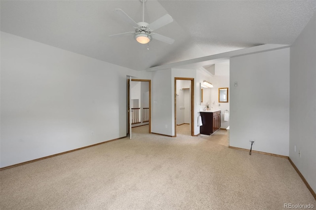 2859 Front Royal Dr, Colorado Springs, CO 80919 - unfurnished bedroom with light carpet, vaulted ceiling, ensuite bathroom, and a ceiling fan