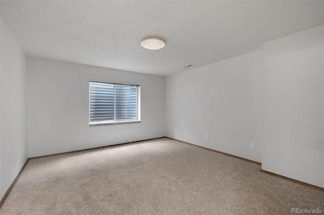 2859 Front Royal Dr, Colorado Springs, CO 80919 - carpeted spare room featuring baseboards and a textured ceiling